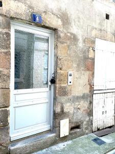 a door on a brick building with a sign next to it at Studio dans Quartier historique de MOULINS in Moulins