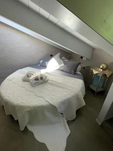 a bedroom with a large white bed with towels on it at ACADAMIS - Suites & Junior Suites in Turin