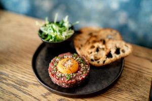 a plate of food with an egg and bread on a table at The Bonnie Badger in Gullane