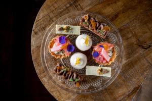 a glass plate with different types of food on a table at The Bonnie Badger in Gullane