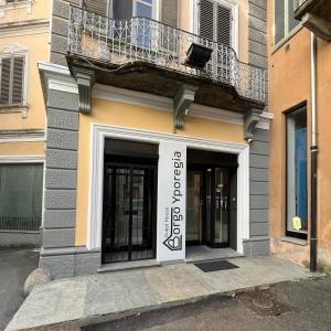 a building with a balcony on top of it at Borgo Yporegia in Ivrea