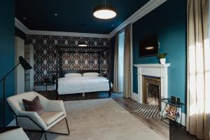 a bedroom with a bed and a fireplace at The Bonnie Badger in Gullane
