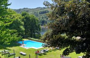 a swimming pool with a view of a lake at AQUAVIEW - VENDA NOVA in Venda Nova