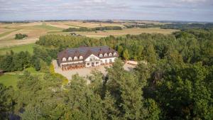 an aerial view of a large house in a field at Pensjonat Cyrkon - strażnik młodszego Paleozoiku in Iwaniska