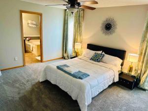 a bedroom with a large bed and a large mirror at The Falmouth Villa with Peloton Bike in Shakopee