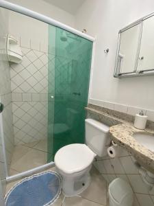 a bathroom with a toilet and a glass shower at Verde e Mar in Angra dos Reis