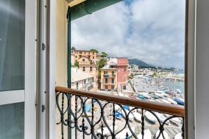 a balcony with a view of a beach and buildings at Seaside Apartment Genova in Genova