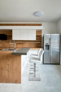 a kitchen with a sink and a refrigerator at WeinlandMotel in Ebenthal