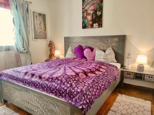 a bedroom with a purple bed with a purple comforter at Nature Finca Apartment - Pure Relaxation in Mazo