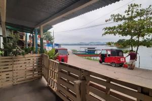 two small vehicles parked on a dock near the water at Habitación Privada Doña Zoila in Flores