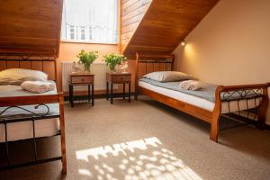 a bedroom with two beds and two night stands at Pensjonat Cyrkon - strażnik młodszego Paleozoiku in Iwaniska