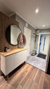 a bathroom with a mirror on the wall and a dresser at Holiday Home Ljungskile in Ljungskile