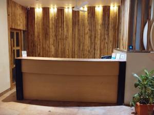 a reception desk in a room with wooden walls at Hotel Shripad Continental in Amravati