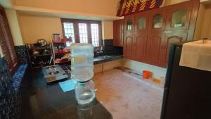 a kitchen with a glass vase sitting on top of a counter at PALAZHI in Kovalam