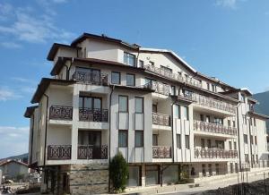 a large white building with balconies on it at Diamond Heights apartament in Bansko