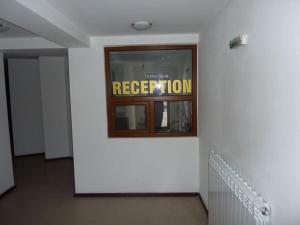 a white wall with a sign in a window at Diamond Heights apartament in Bansko