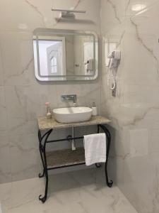 a bathroom with a sink and a mirror at Pokoje Gościnne PLUS in Ustka