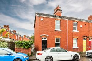 two cars parked in front of a red brick house at The Broadway Bath - 2 Bedrooms with parking, Central Bath in Bath