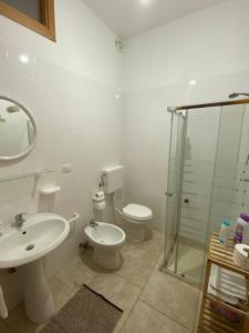 a bathroom with a sink and a toilet and a shower at Salento da amare in Marina di Mancaversa