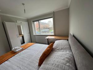 um quarto com uma cama grande e uma janela em The Coral 24 Guest House MilBrook Southampton em Southampton