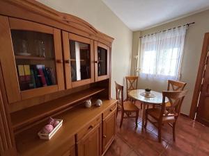 a kitchen with a table and a dining room at Casa Rural Cerezo in Torviscón
