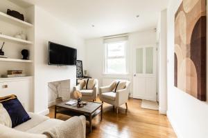 a living room with two couches and a tv at The Broadway Bath - 2 Bedrooms with parking, Central Bath in Bath