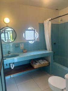 a blue bathroom with a sink and a toilet at Casa Matia Bed and Breakfast in San Miguel de Allende