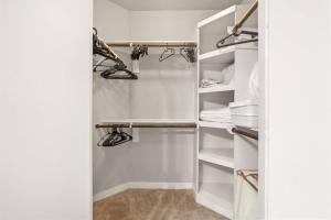 a walk in closet with white shelves at 1BRModern Retreat-Mins to Med Center in Houston