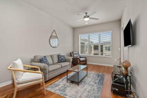 a living room with a couch and a tv at 1BRModern Retreat-Mins to Med Center in Houston