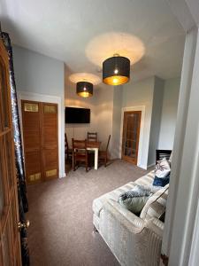 a living room with a couch and a table at Castle Brae Apartment in Stirling