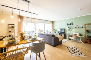 uma sala de estar com uma mesa e um sofá em FeWo Ahrperle-modernes Apartment-Balkon-Kurviertel em Bad Neuenahr-Ahrweiler