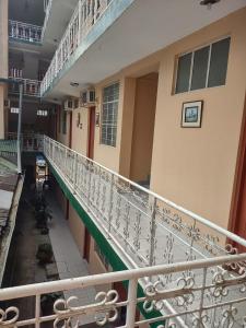 a balcony of a building with a white railing at HOTEL SOL Y LUNA in Iquitos
