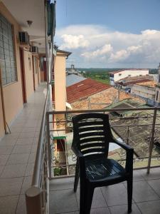 una silla negra sentada en el balcón de un edificio en HOTEL SOL Y LUNA, en Iquitos