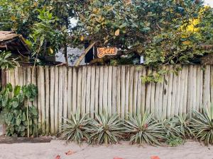 a wooden fence with a sign on top of it at Pousada Zen Caraiva in Caraíva +74 photos