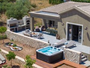 een achtertuin met een zwembad en een huis bij Villa Rodamos in Karavomylos