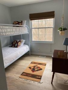 a bedroom with a bunk bed and a desk at BlueHaven: Your Cozy Lakeside Retreat in Glenn