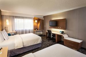 a hotel room with two beds and a desk at Courtyard by Marriott Henderson - Green Valley - Las Vegas in Las Vegas