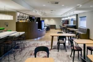 a restaurant with tables and chairs and a bar at Courtyard by Marriott Henderson - Green Valley - Las Vegas in Las Vegas