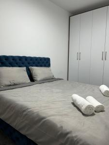 a bedroom with a large bed with two towels on it at Star Apartments 1 in Novi Pazar