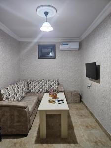 a living room with a couch and a table at Galstyans HOTEL EVN Airport in Yerevan