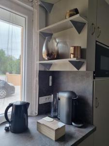 a kitchen with a counter with a coffee maker on it at Fleur d'Or Proche ŔER C Evry in Brétigny-sur-Orge