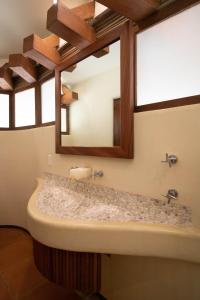 a bathroom with a sink and a mirror at Condo BEACH FRONT PLAYA BLANCA GARDEN in Zihuatanejo +34 photos