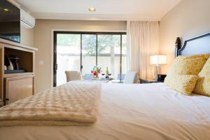 a bedroom with a large bed with a large window at Gorgeous Napa Valley Getaway - Steps from Wineries in Napa