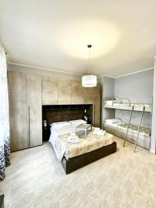a large bedroom with a large bed and a chandelier at la casa sul lago in Scafa
