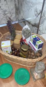 a basket of food on a table with green plates at Bujtina Rakaj in Bogë