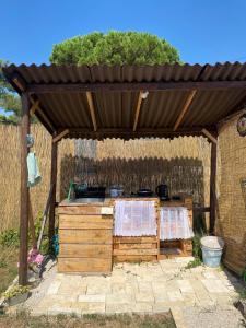 a wooden pergola with a counter in a yard at Camping Perla in Zadar