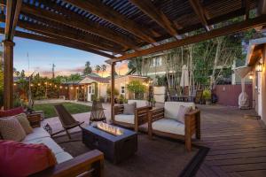 a patio with couches and chairs on a wooden deck at Relax in a Gorgeous 6 Person Quaint Home in San Jose