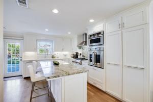 a white kitchen with white cabinets and a counter top at Relax in a Gorgeous 6 Person Quaint Home in San Jose