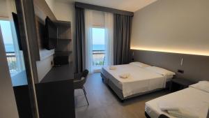 Postel nebo postele na pokoji v ubytování Hotel Giannini