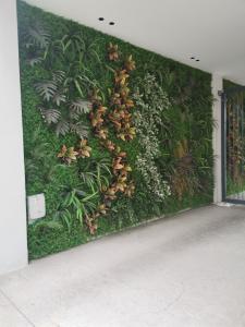 a green wall with plants on it in a building at B&B Portello Le Terrazze 1 in Milan